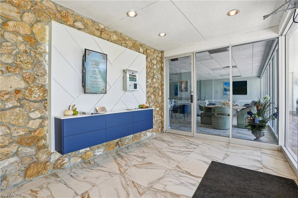 5 Bluebill Avenue, Unit 301 Naples, FL 34108 - Photo 36 of 48 a bed room with a bed and a television