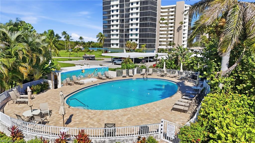 5 Bluebill Avenue, Unit 301 Naples, FL 34108 - Photo 37 of 48 a view of a swimming pool with outdoor seating