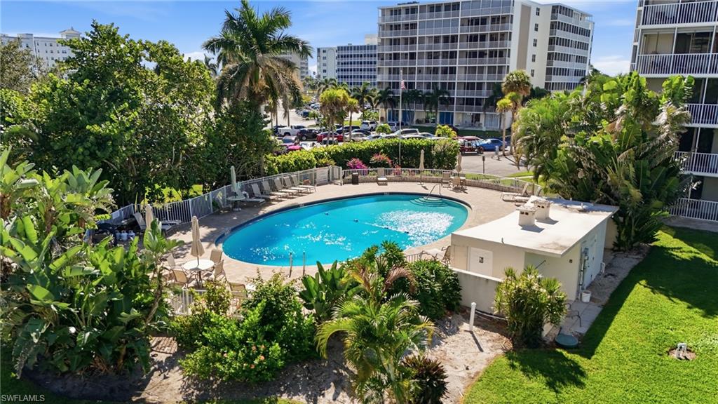 5 Bluebill Avenue, Unit 301 Naples, FL 34108 - Photo 38 of 48 a view of a swimming pool with a patio
