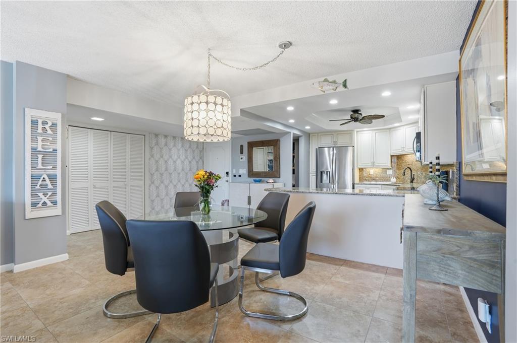 5 Bluebill Avenue, Unit 301 Naples, FL 34108 - Photo 10 of 48 a view of a dining room with furniture