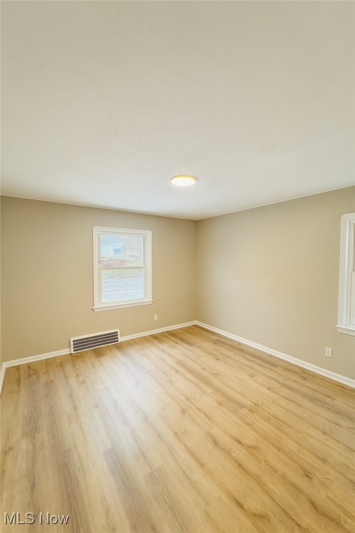 14505 Triskett Road Cleveland, OH 44111 - Photo 6 of 15 Spare room with baseboards and light wood-style floors