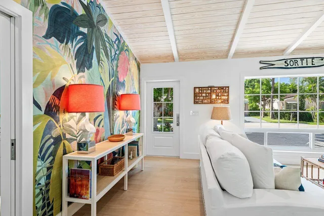 a living room with a couch a rug and a large window