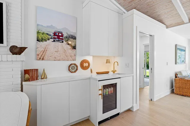 a storage room with wooden floor washer and dryer