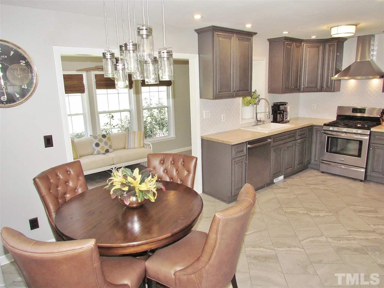 1217 Somerset Road Raleigh, NC 27610 - Photo 4 of 29 a kitchen with a table and chairs