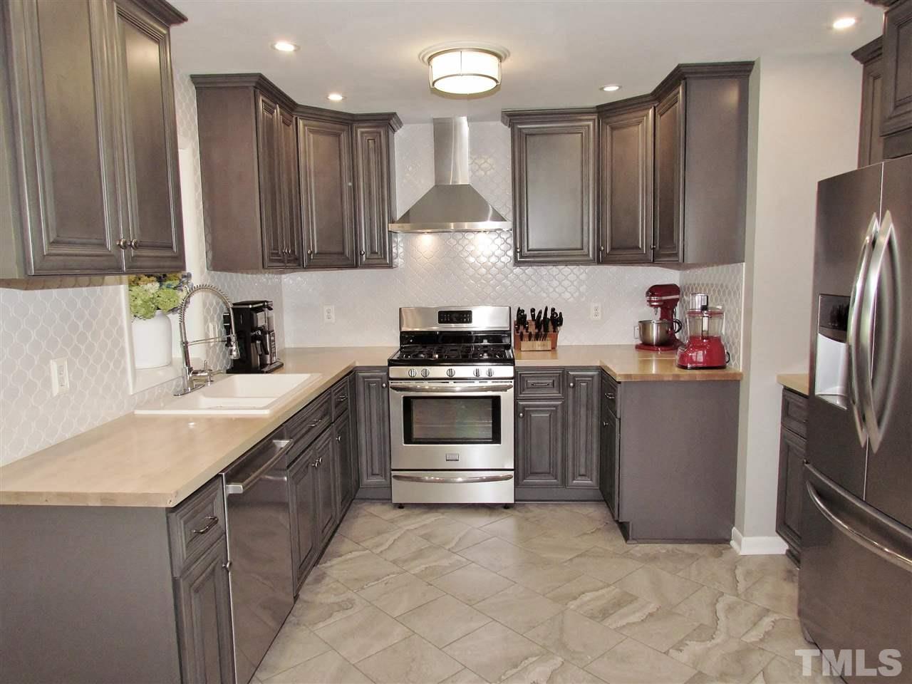 1217 Somerset Road Raleigh, NC 27610 - Photo 5 of 29 a kitchen with a sink stove and refrigerator