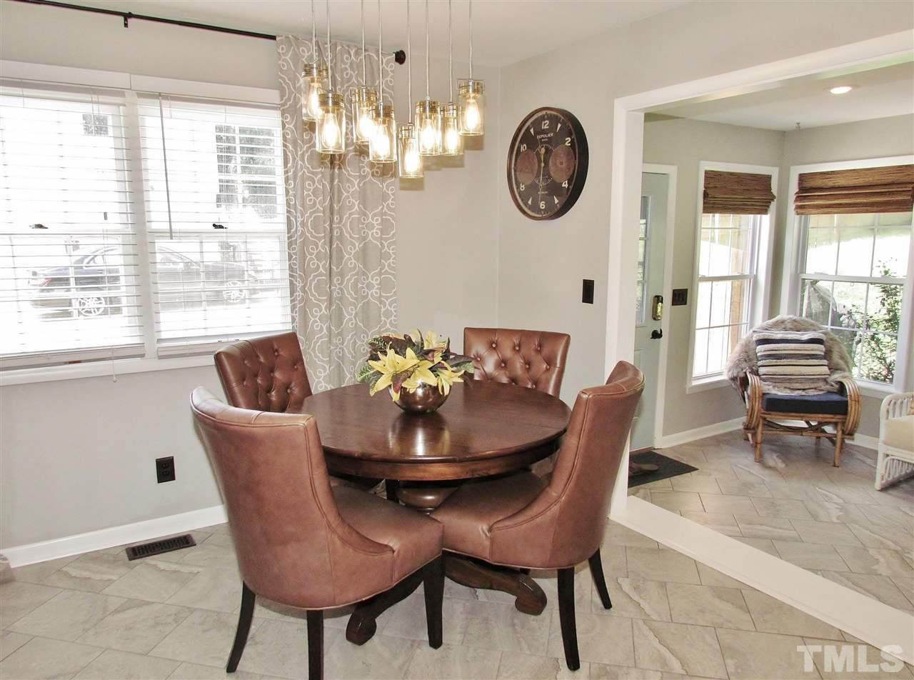 1217 Somerset Road Raleigh, NC 27610 - Photo 7 of 29 a dining room with furniture a rug and a window