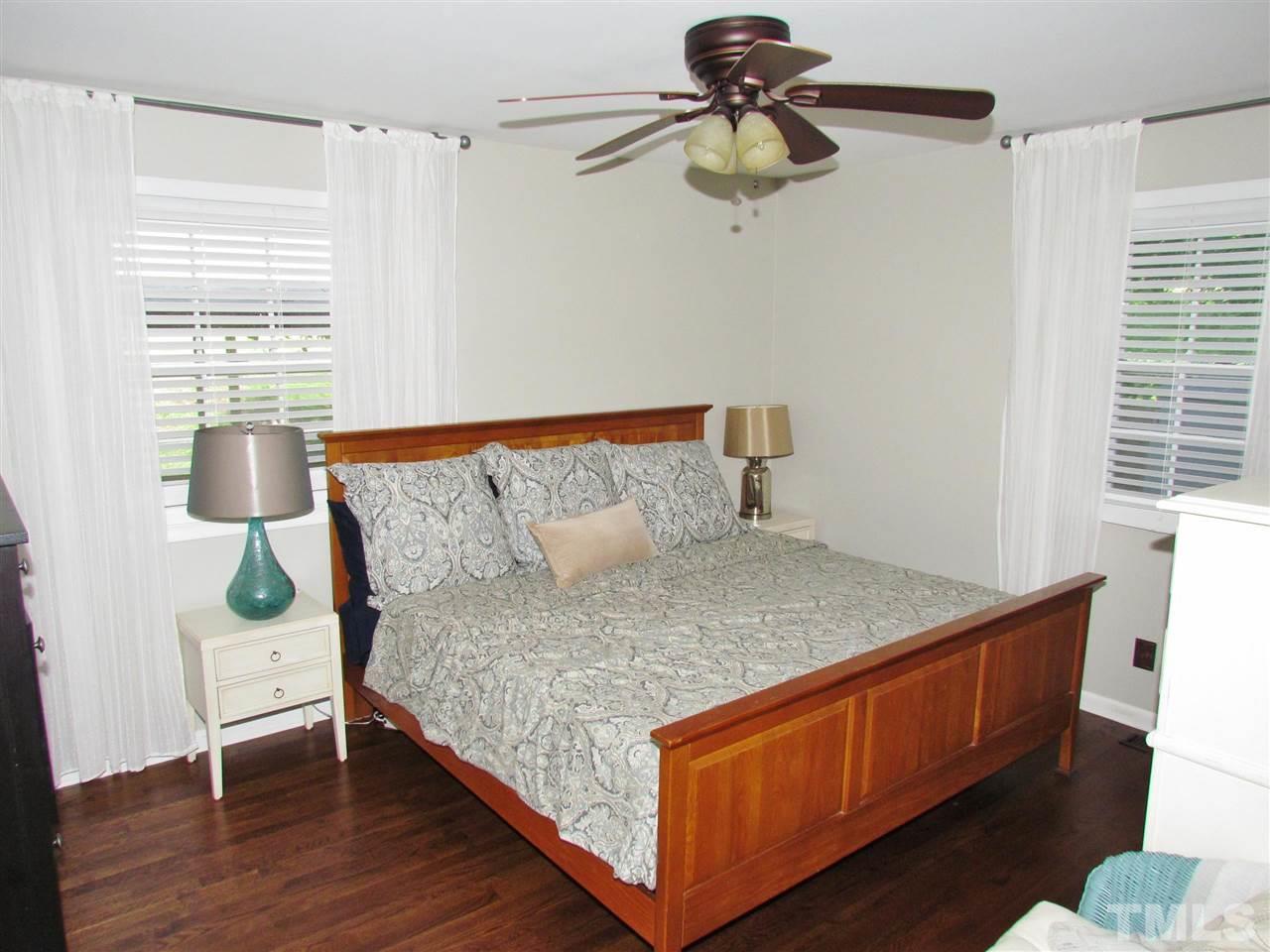 1217 Somerset Road Raleigh, NC 27610 - Photo 8 of 29 a bedroom with a bed a window and couch