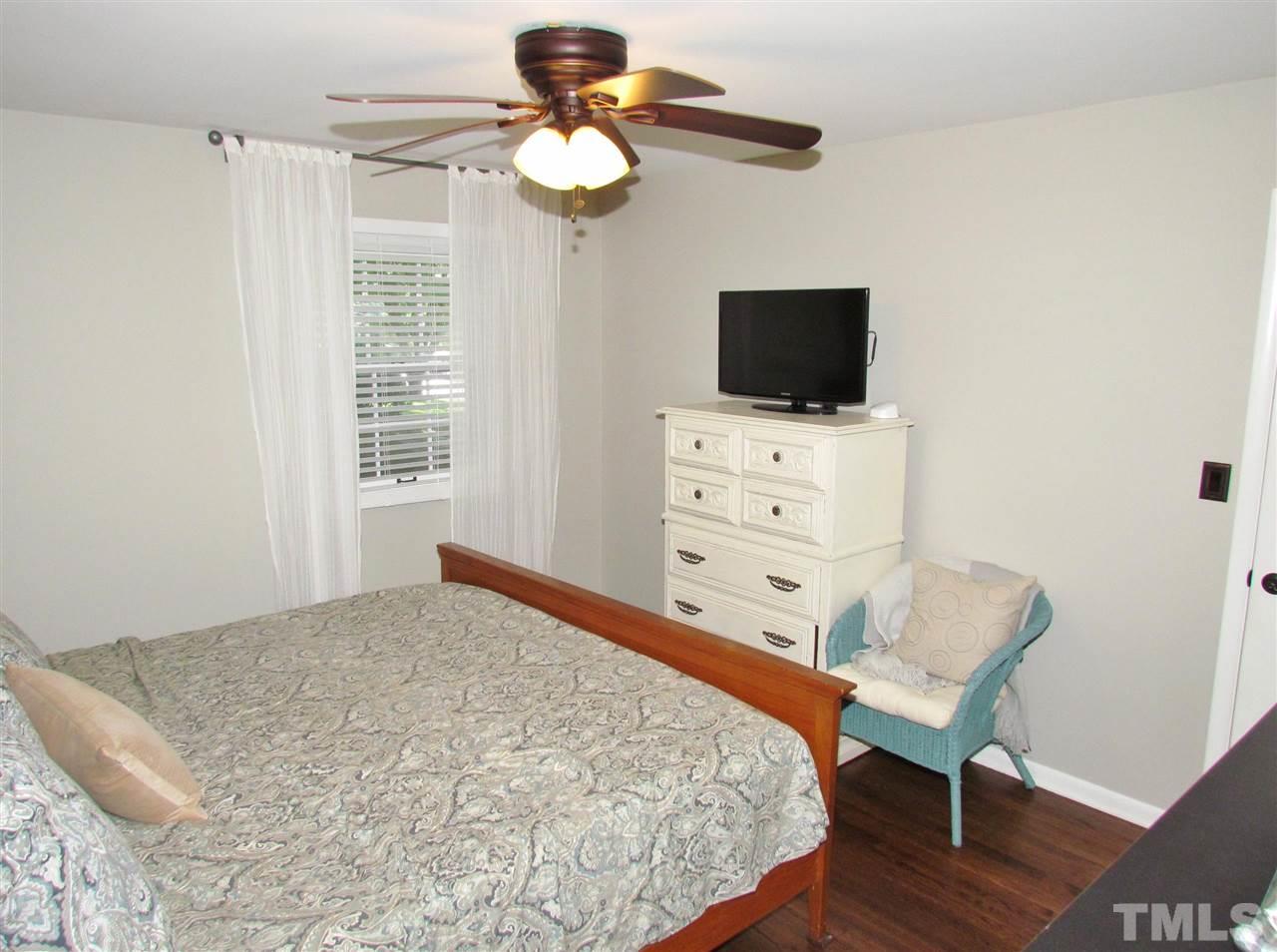 1217 Somerset Road Raleigh, NC 27610 - Photo 9 of 29 a bedroom with a bed and a flat screen tv