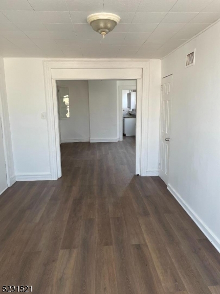 142 Hudson Street, Unit 2 Newark, NJ 07103 - Photo 3 of 13 a view of a livingroom with wooden floor and closet