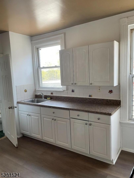 142 Hudson Street, Unit 2 Newark, NJ 07103 - Photo 7 of 13 a kitchen with granite countertop white cabinets and a sink