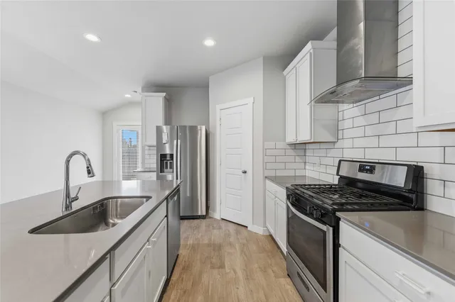 a kitchen that has a sink and a stove