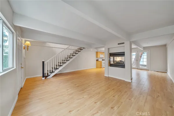 a view of an entryway with wooden floor