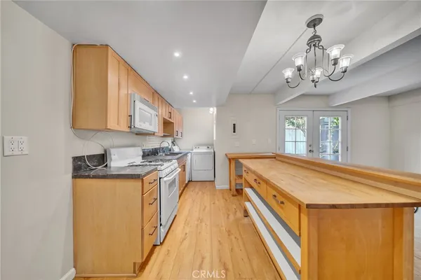 a spacious kitchen with stainless steel appliances granite countertop a sink and cabinets