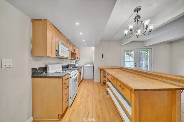 a spacious kitchen with stainless steel appliances granite countertop a sink and cabinets