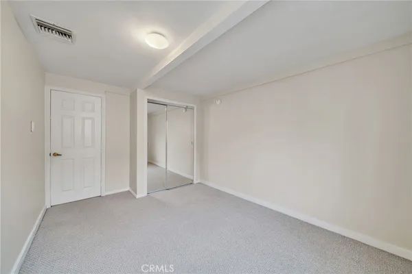 a view of an empty room and closet area