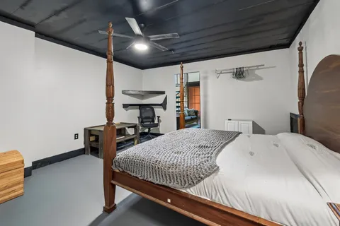 a bedroom with a bed and a chandelier