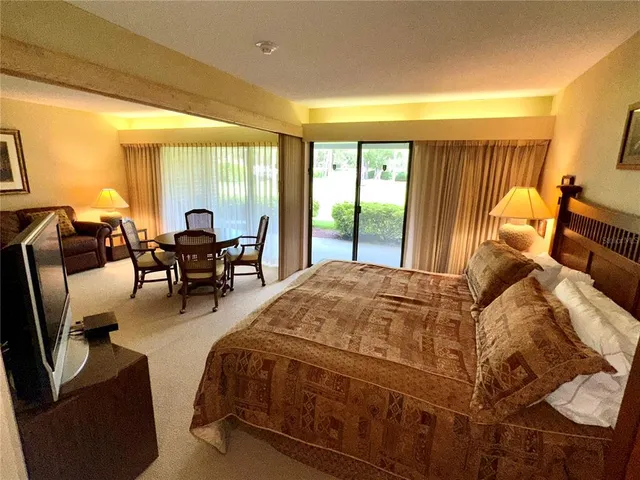 a spacious bedroom with a bed and large windows