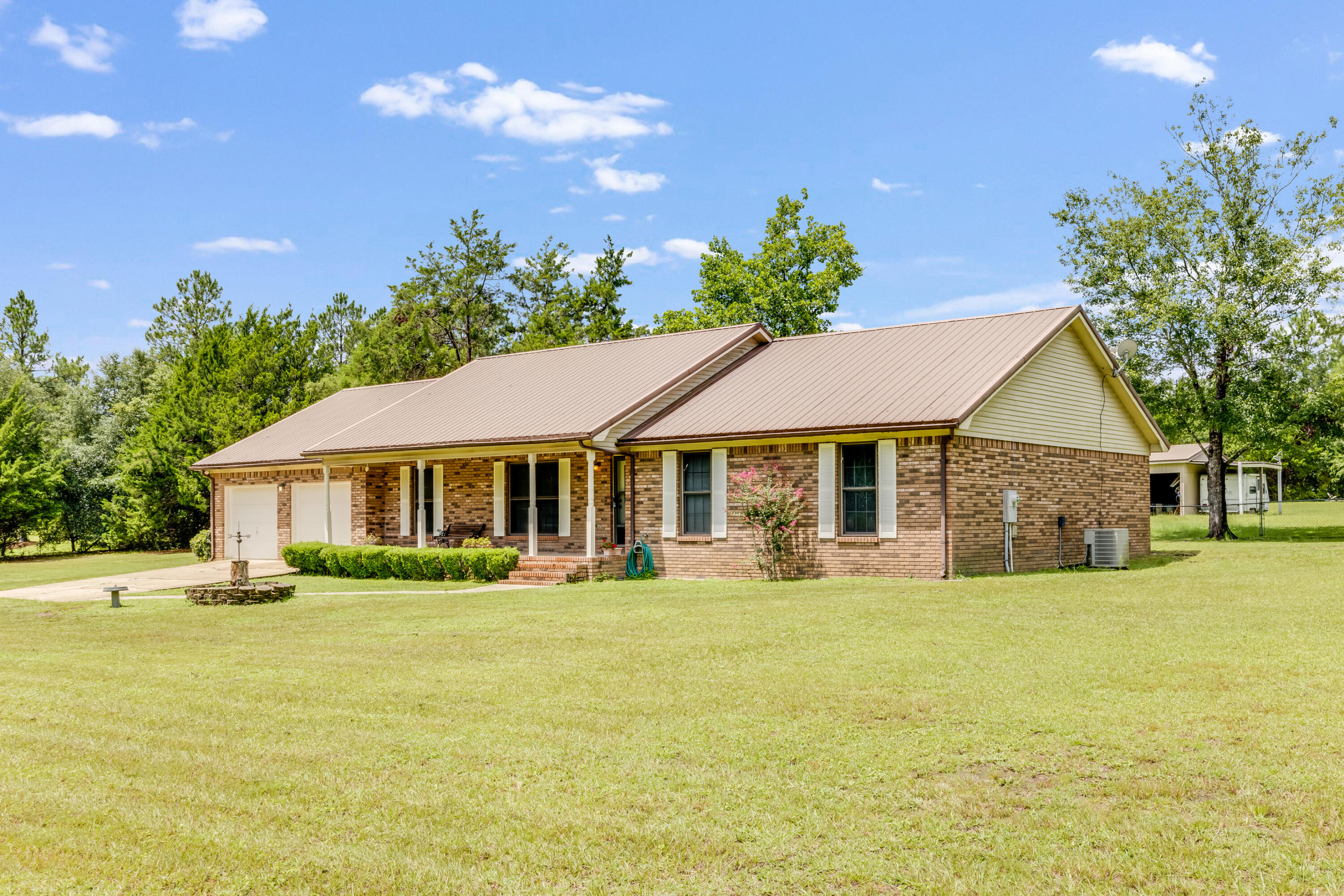 5892 Jack Stokes Road Baker, FL 32531 - Photo 1 of 49 a front view of a house with a garden