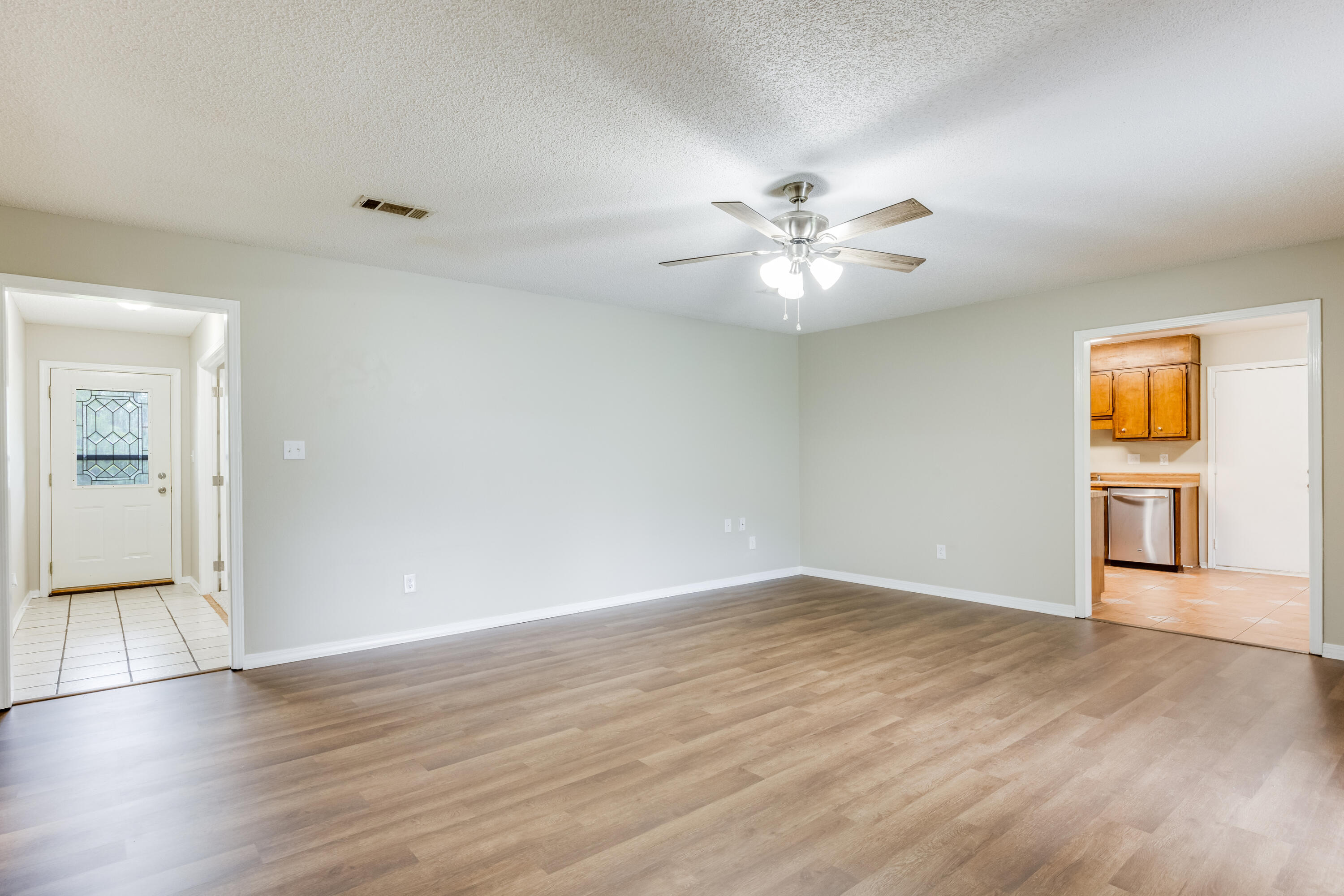 5892 Jack Stokes Road Baker, FL 32531 - Photo 12 of 49 wooden floor in an empty room with a window
