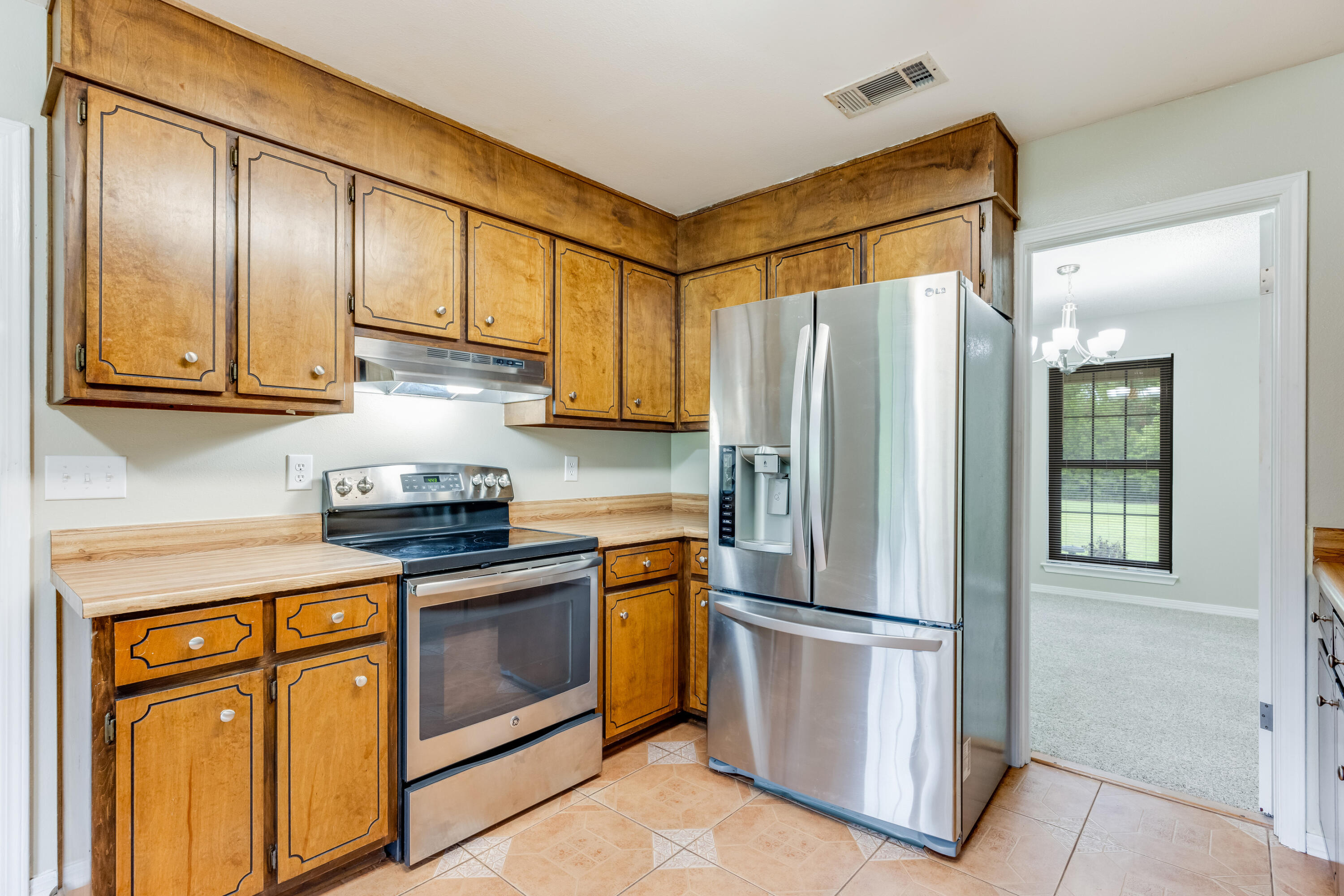 5892 Jack Stokes Road Baker, FL 32531 - Photo 14 of 49 a kitchen with stainless steel appliances granite countertop a refrigerator stove and sink