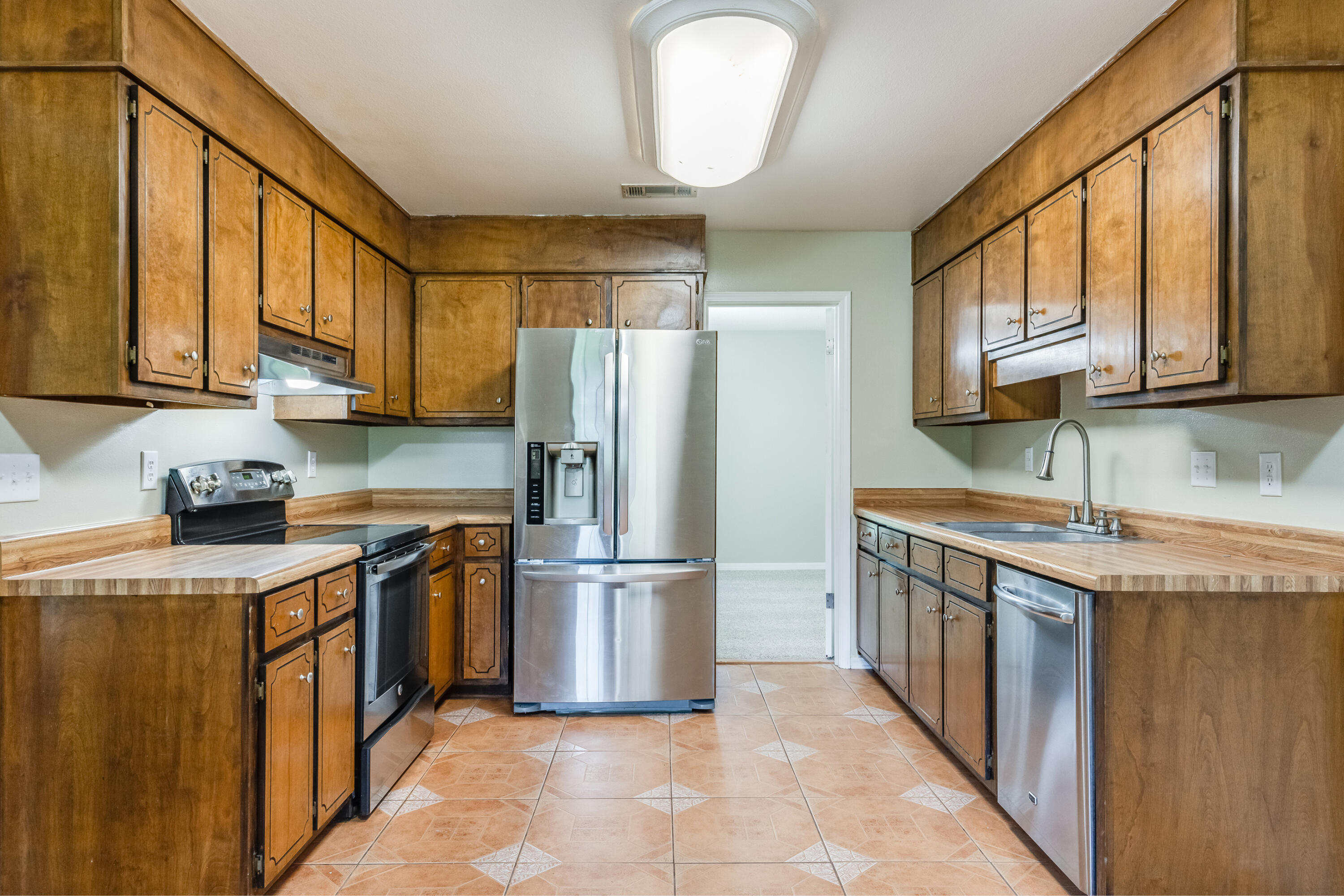 5892 Jack Stokes Road Baker, FL 32531 - Photo 16 of 49 a kitchen with stainless steel appliances granite countertop a stove a refrigerator a sink and dishwasher