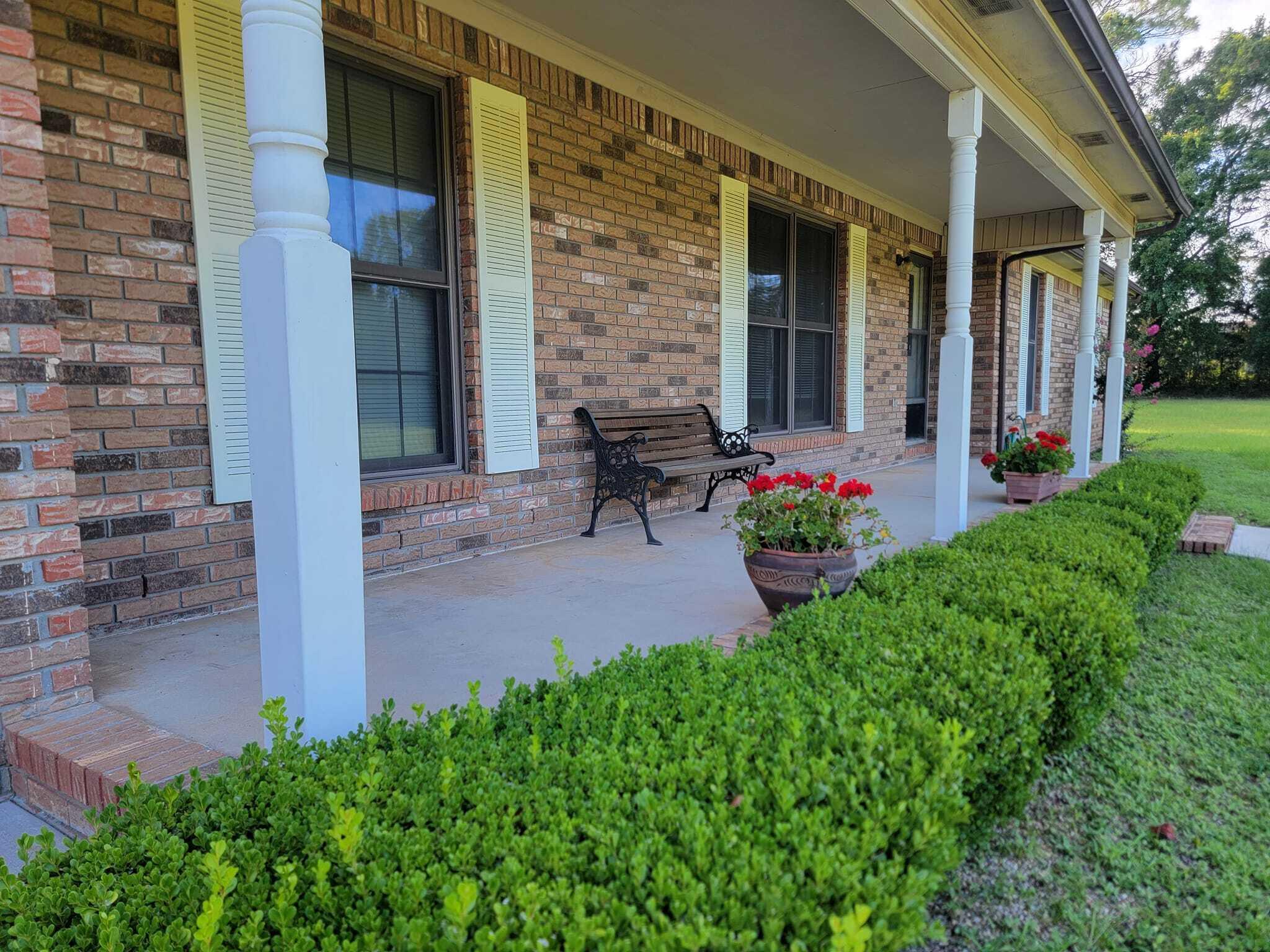 5892 Jack Stokes Road Baker, FL 32531 - Photo 2 of 49 a view of a patio with table and chairs and potted plants