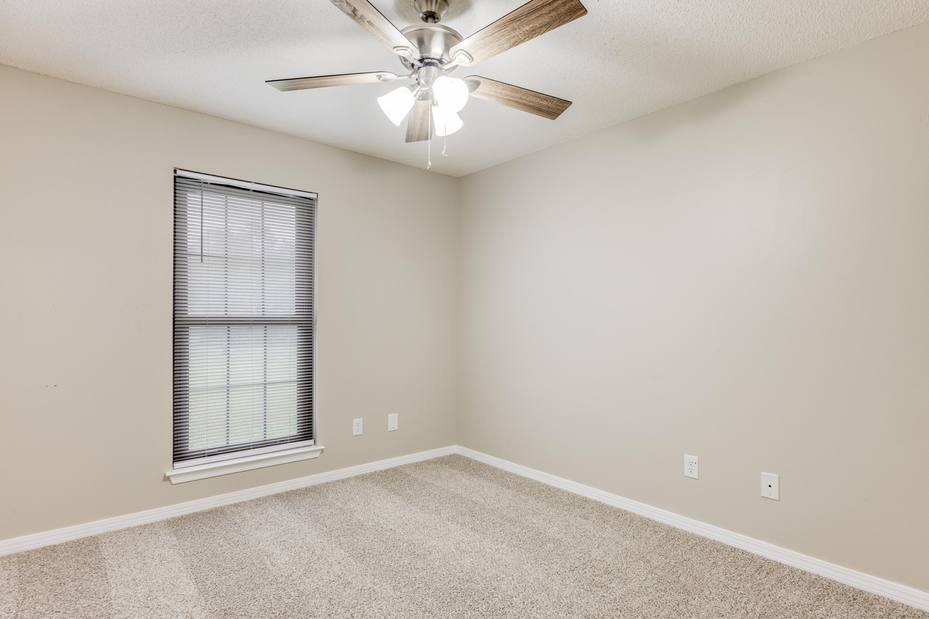 5892 Jack Stokes Road Baker, FL 32531 - Photo 24 of 49 an empty room with a windows and ceiling fan