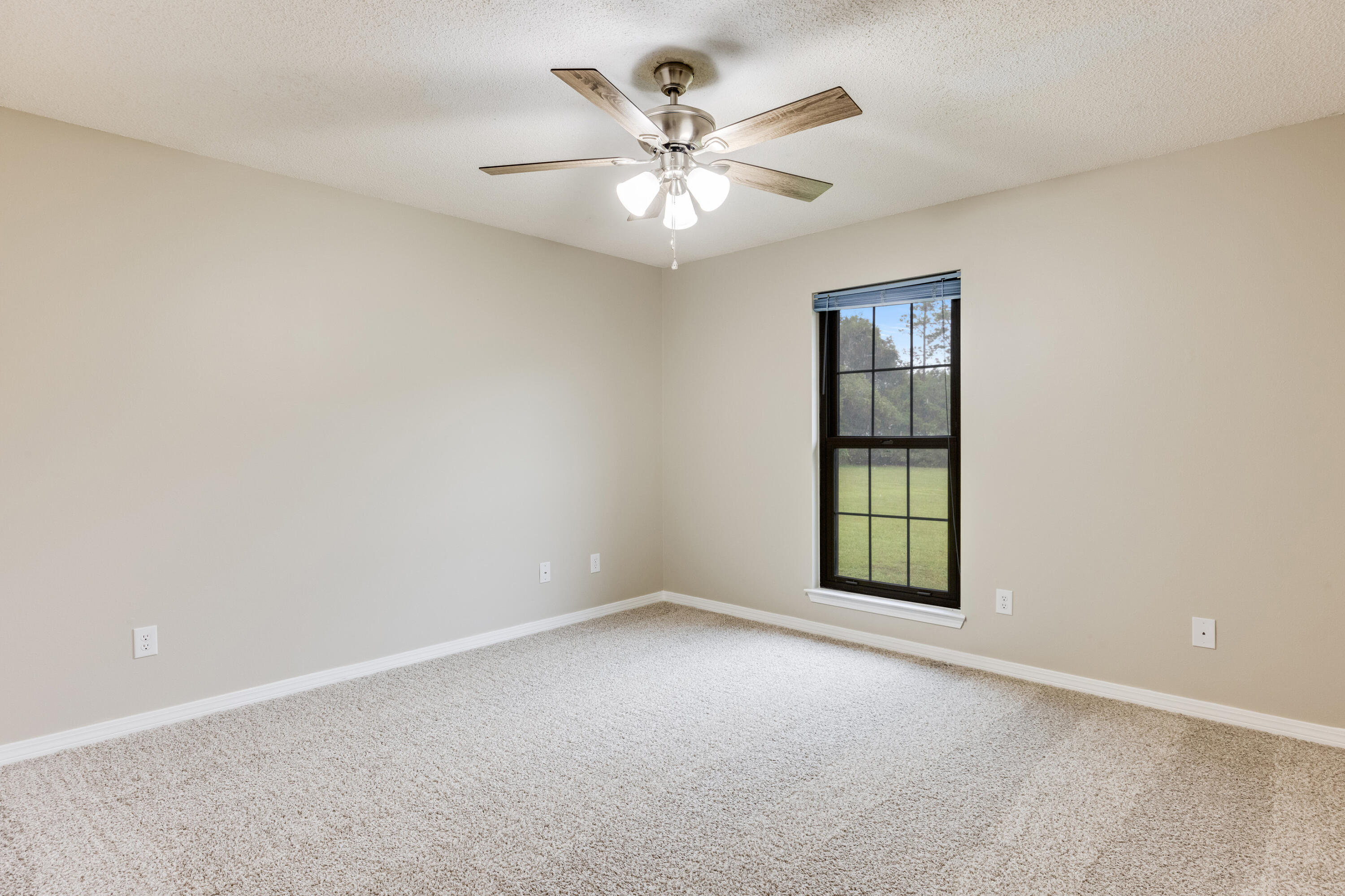 5892 Jack Stokes Road Baker, FL 32531 - Photo 26 of 49 an empty room with windows and ceiling fan