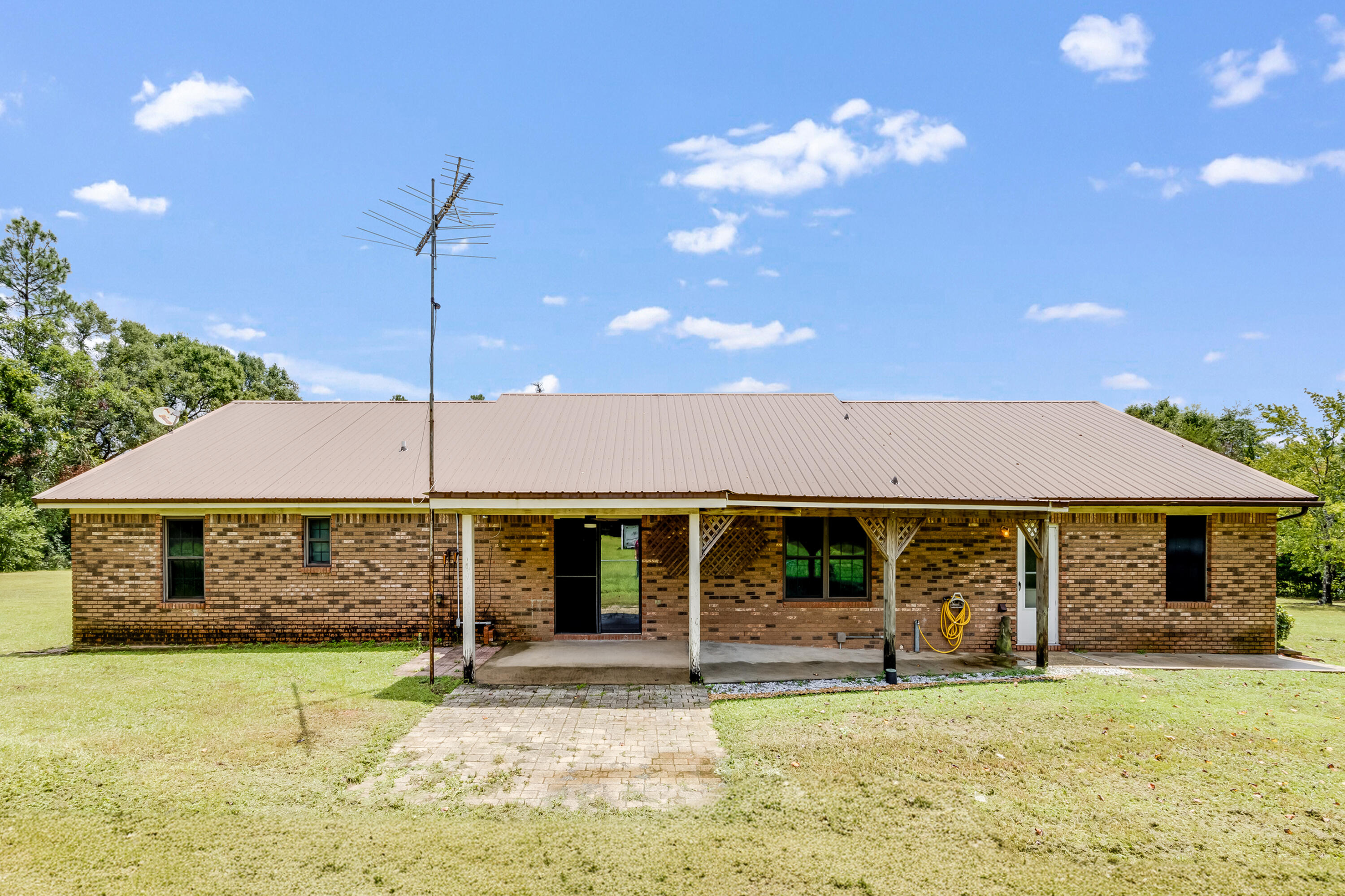 5892 Jack Stokes Road Baker, FL 32531 - Photo 29 of 49 a front view of a house with a garden and porch