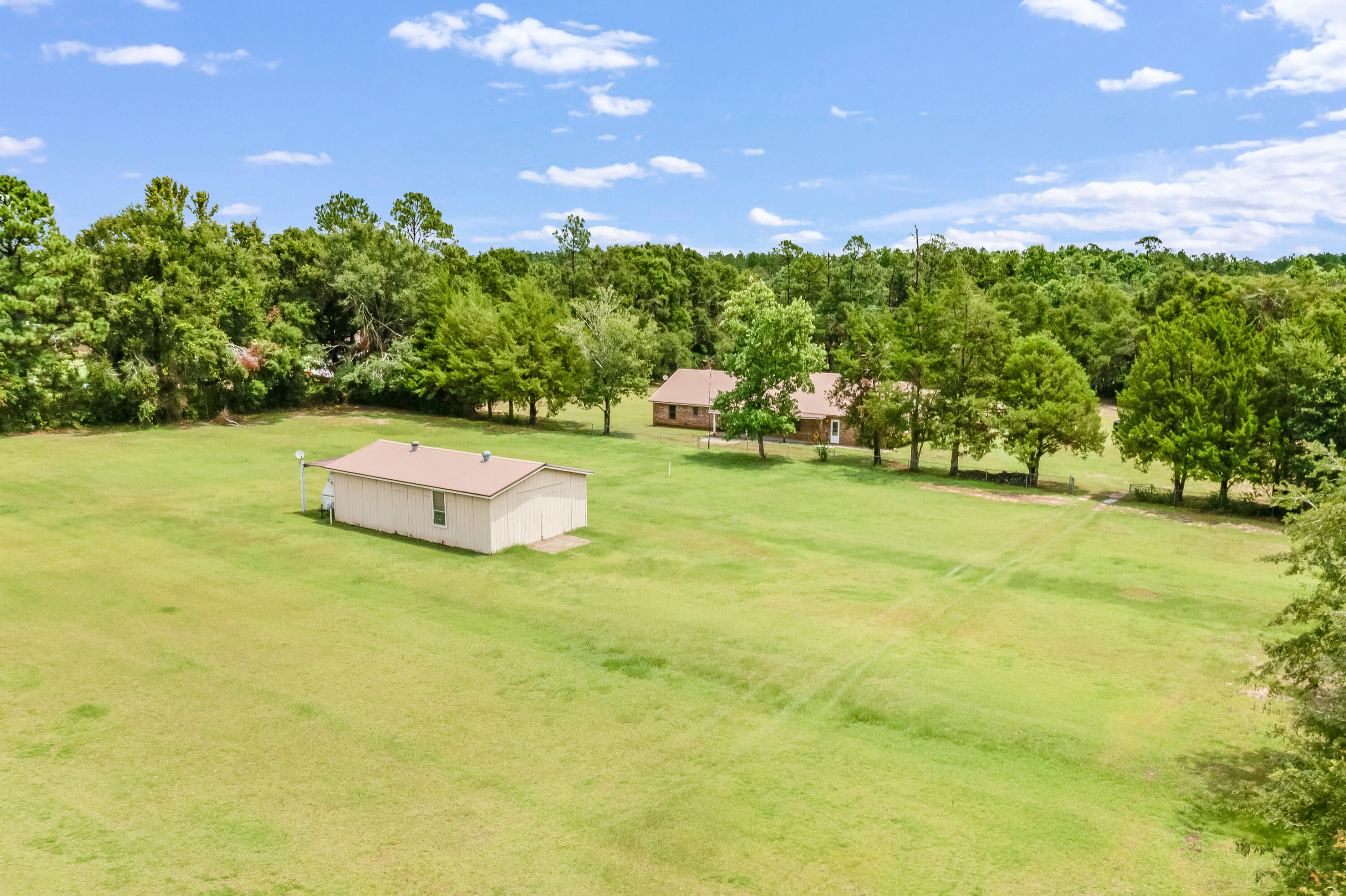 5892 Jack Stokes Road Baker, FL 32531 - Photo 37 of 49 a view of a big yard with a table and a fire pit