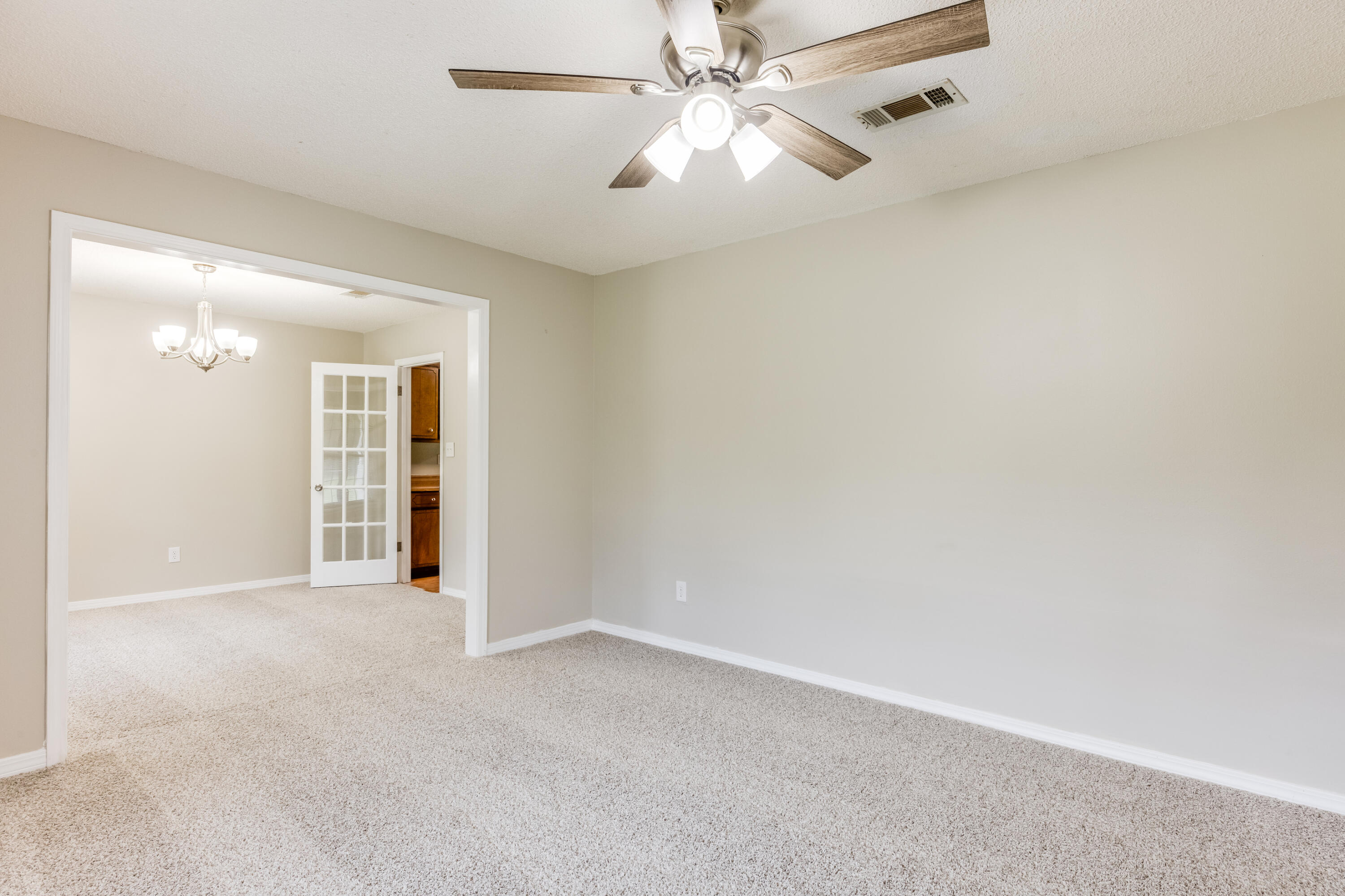 5892 Jack Stokes Road Baker, FL 32531 - Photo 6 of 49 an empty room with fan and a ceiling fan
