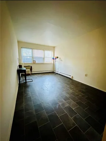 a view of a livingroom with furniture and an window
