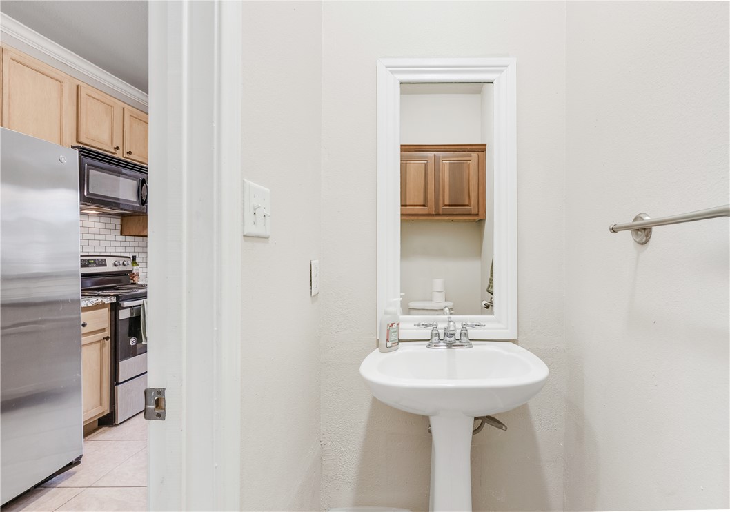 1425 West Villa Maria Road, Unit 1004 Bryan, TX 77801 - Photo 12 of 23 a bathroom with a sink and a mirror