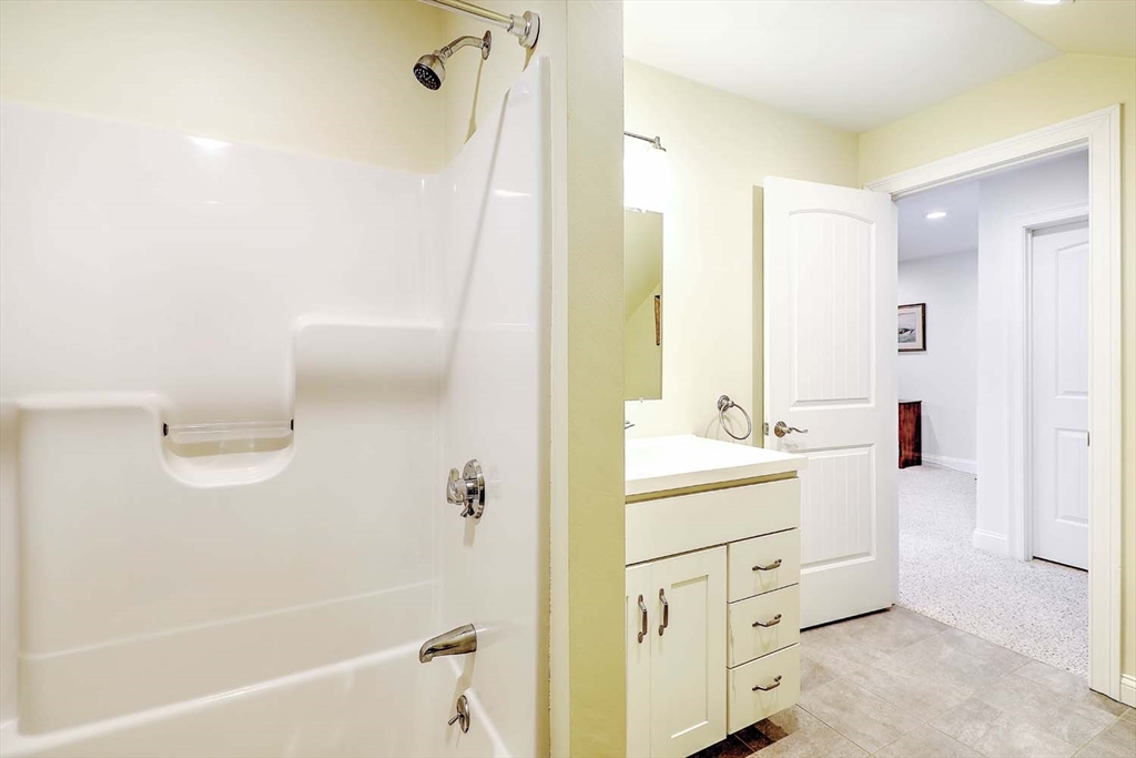 1346 Main Road, Unit 7 Westport, MA 02790 - Photo 17 of 20 a bathroom with a sink a mirror and a bathtub