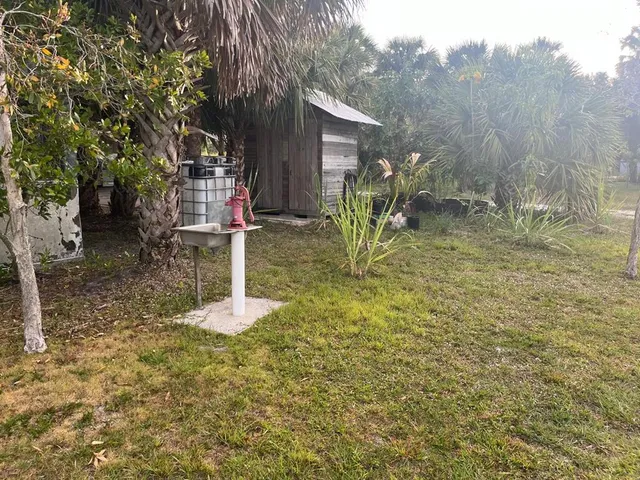 a backyard of a house with table and chairs