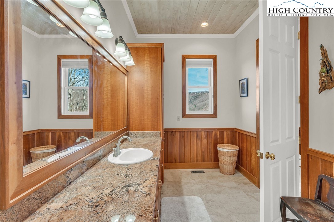 933 Thunder Ridge Lane Lenoir, NC 28645 - Photo 25 of 45 a bathroom with a tub sink and mirror