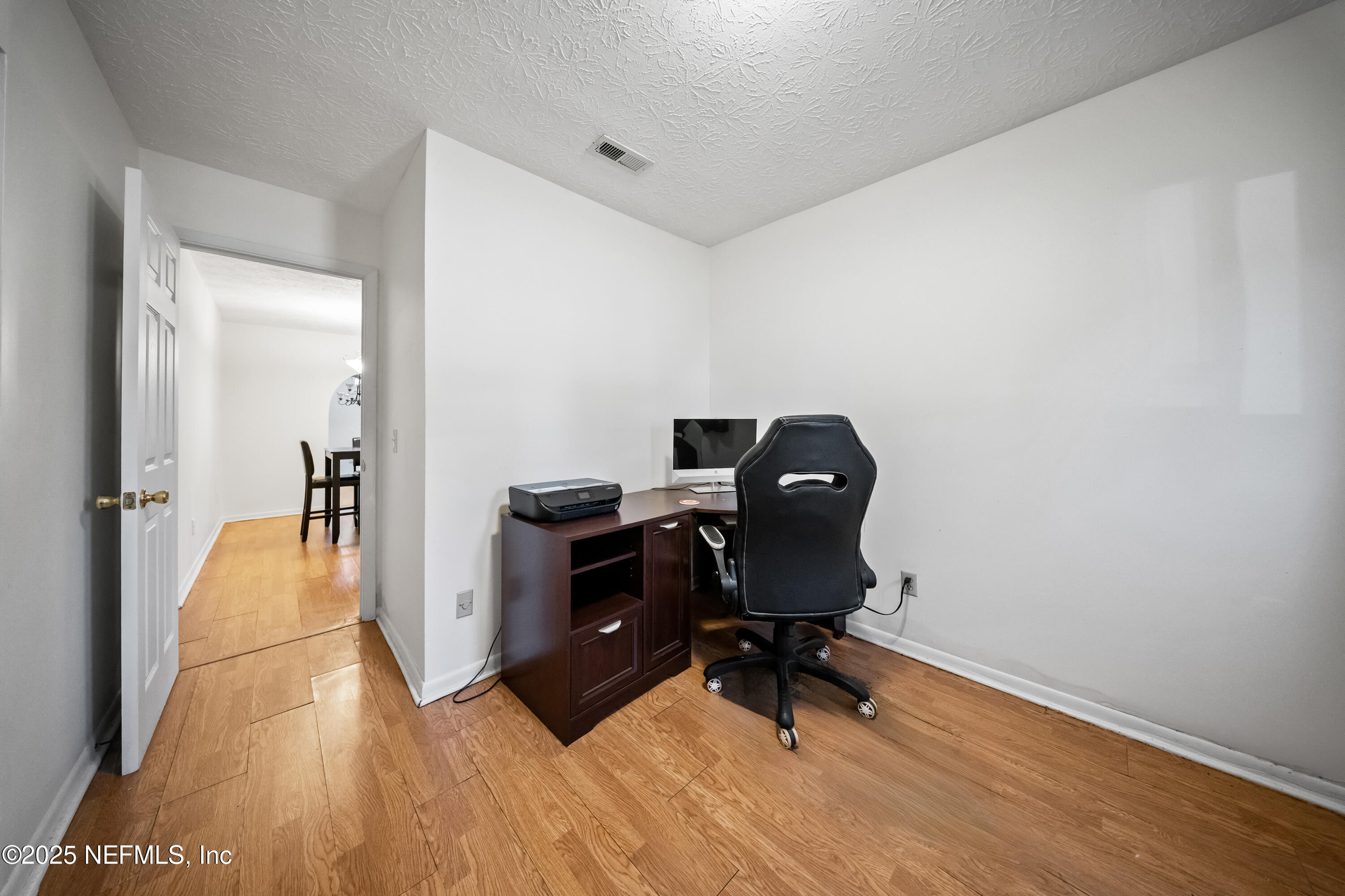 8342 Barracuda Road Jacksonville, FL 32244 - Photo 11 of 20 a view of workspace with wooden floor outdoor space