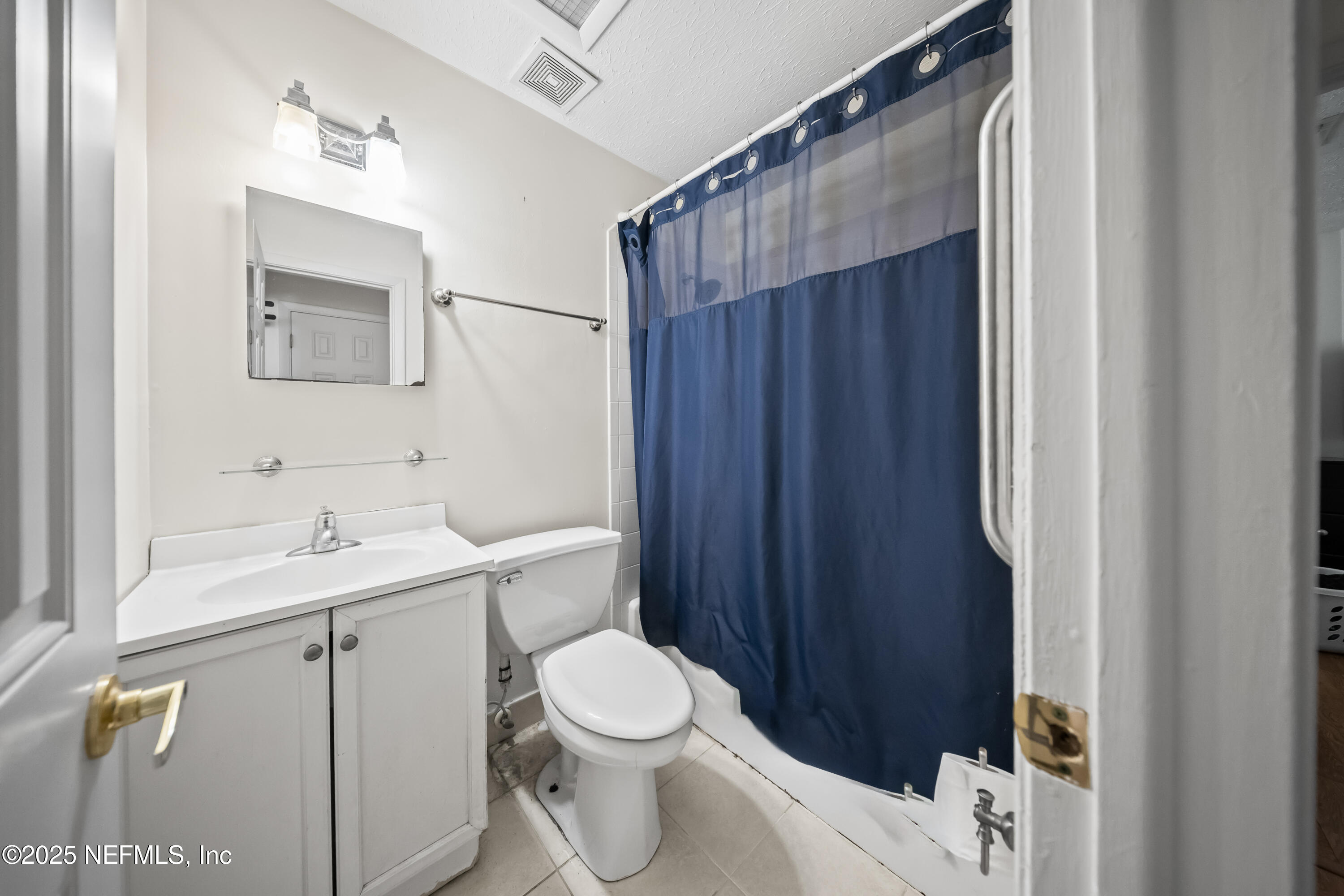 8342 Barracuda Road Jacksonville, FL 32244 - Photo 13 of 20 a bathroom with a toilet a sink and mirror