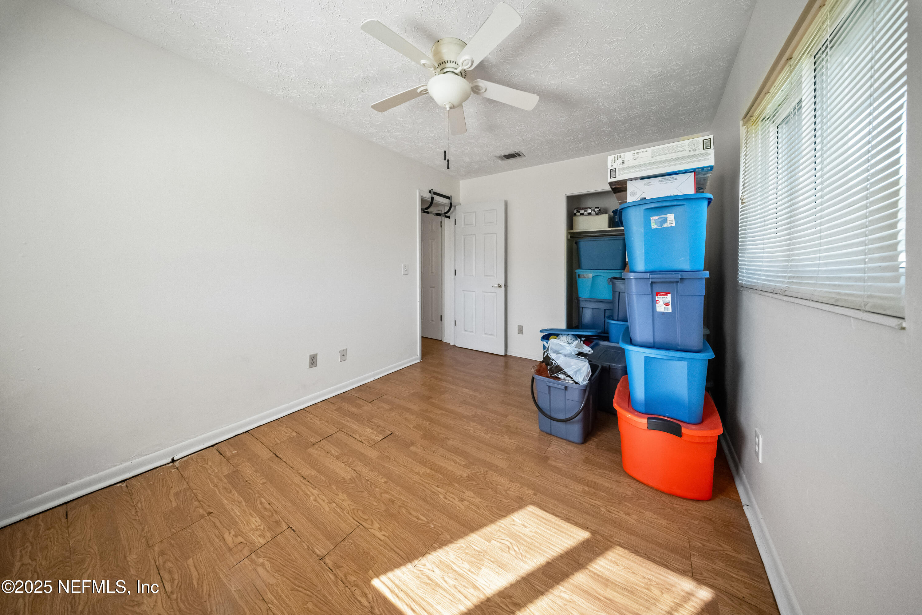 8342 Barracuda Road Jacksonville, FL 32244 - Photo 14 of 20 a bedroom with a bed and a chandelier