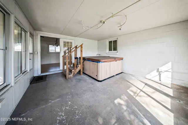 a view of a livingroom with entryway window and stairs