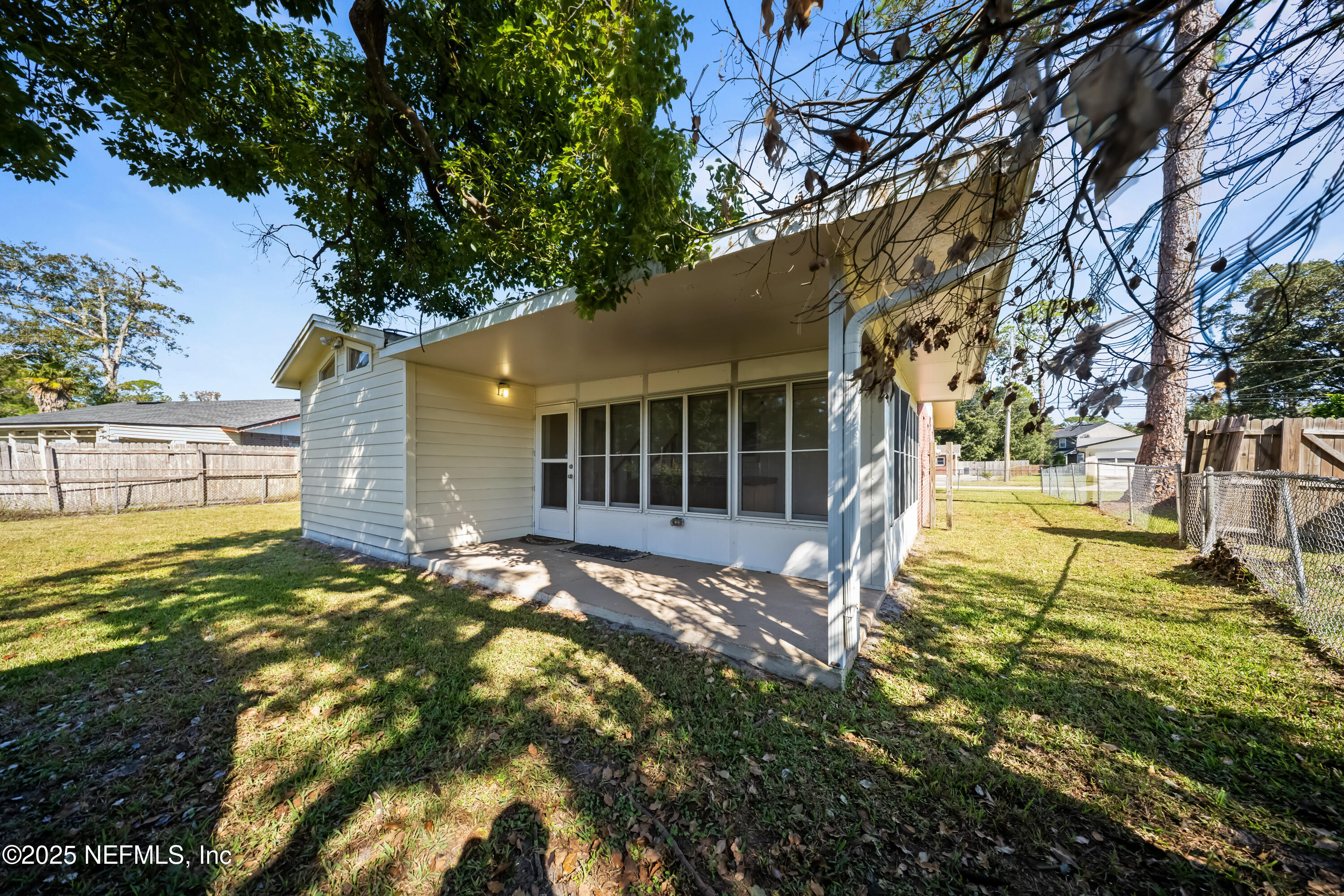 8342 Barracuda Road Jacksonville, FL 32244 - Photo 19 of 20 a backyard of a house with table and chairs