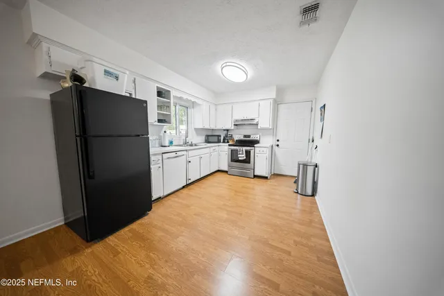 a kitchen with stainless steel appliances a refrigerator and a stove