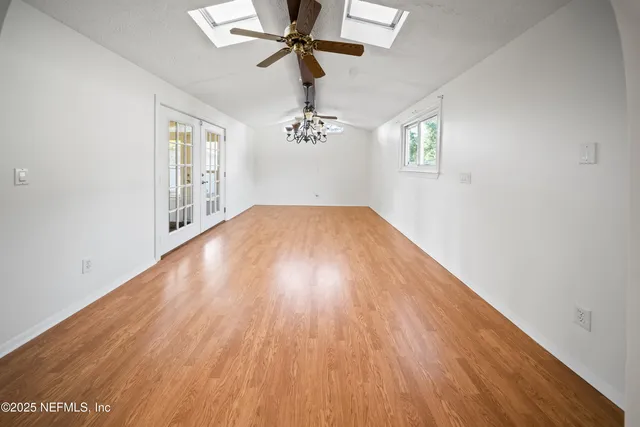 wooden floor in an empty room with a window