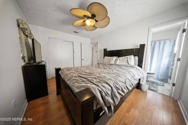 a bedroom with a bed and a chandelier