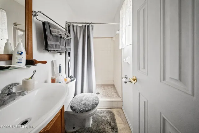a bathroom with a sink toilet and shower