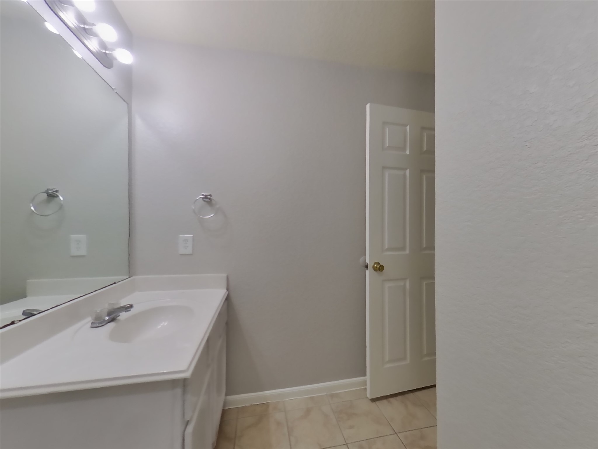 19626 Beachy Court Katy, TX 77449 - Photo 15 of 19 a bathroom with a sink a mirror and vanity