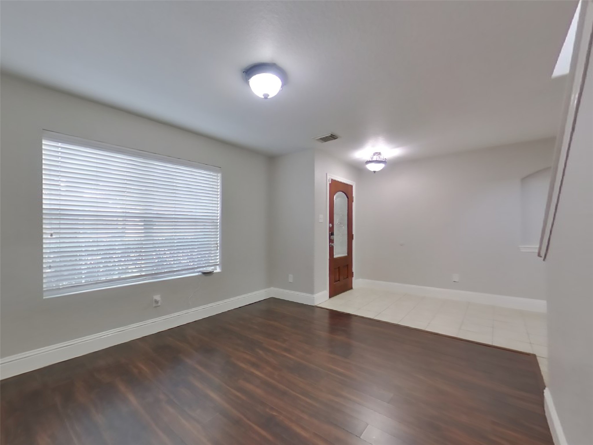 19626 Beachy Court Katy, TX 77449 - Photo 5 of 19 an empty room with wooden floor and windows