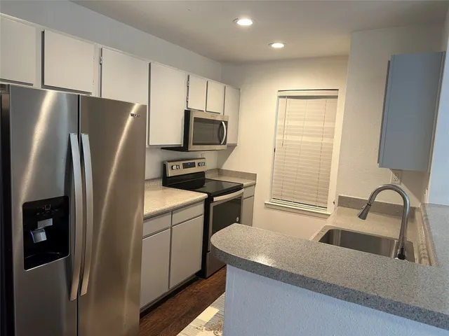 a kitchen with a refrigerator stove and sink