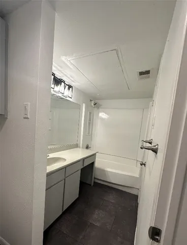 a bathroom with a bathtub and a sink