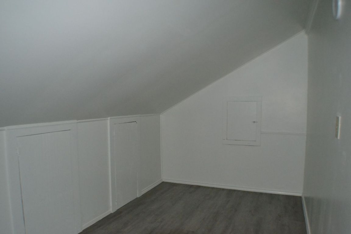 4506 Adelphi Lane Austin, TX 78727 - Photo 11 of 13 Bonus room featuring lofted ceiling and dark wood-type flooring